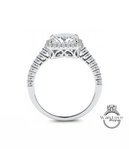 A close-up view of a diamond engagement ring with a large central diamond surrounded by smaller diamonds set in a halo.