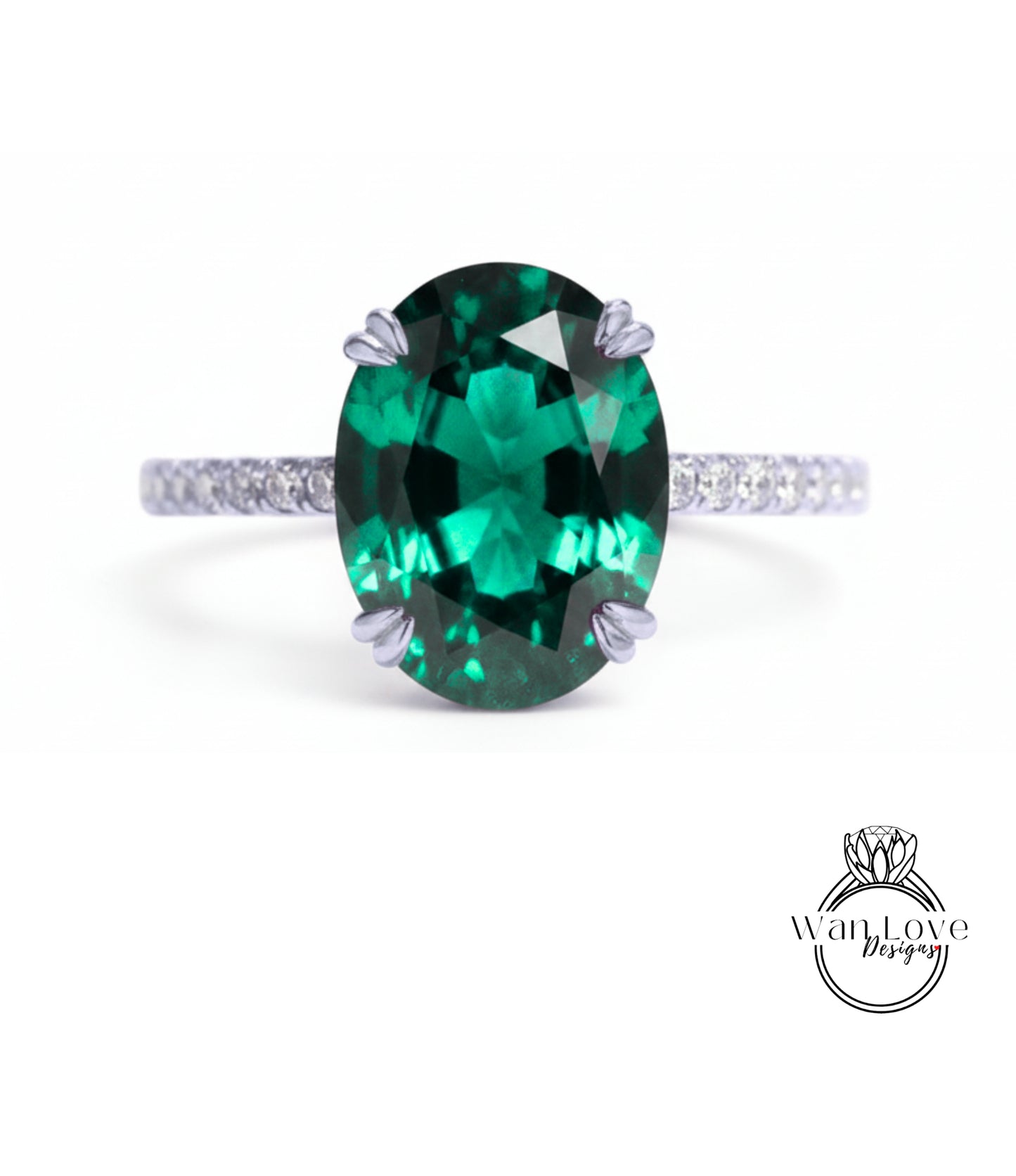 A large oval-shaped green gemstone, possibly a sapphire or emerald, set in a silver ring with a small diamond band.