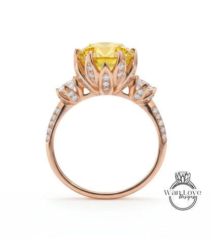 A gold ring with a large yellow gemstone, likely a diamond, set in a floral design with smaller diamonds around the edges.