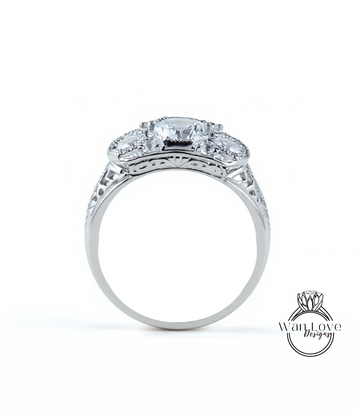 A silver ring with a large central diamond surrounded by smaller diamonds, showcasing intricate metalwork and detailing.