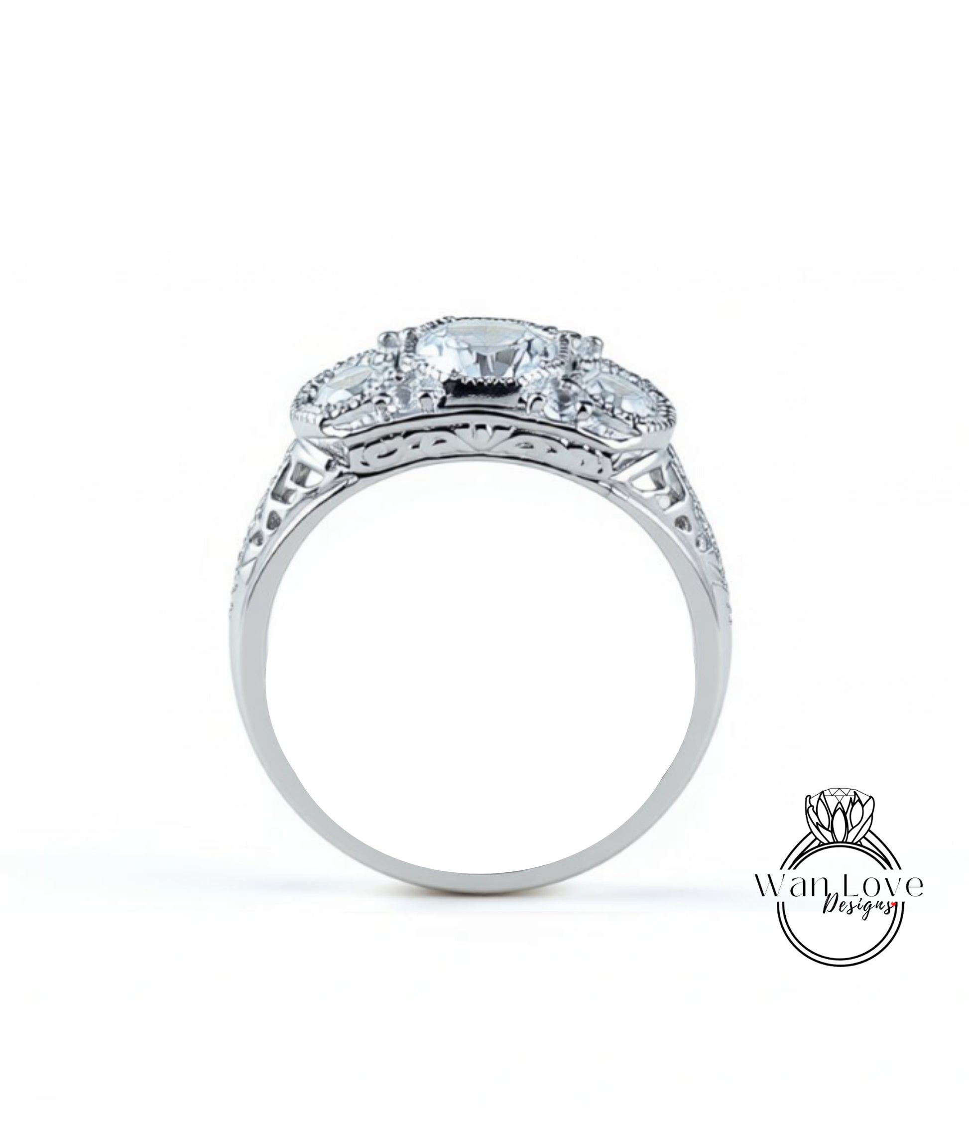A silver ring with a large central diamond surrounded by smaller diamonds, showcasing intricate metalwork and detailing.