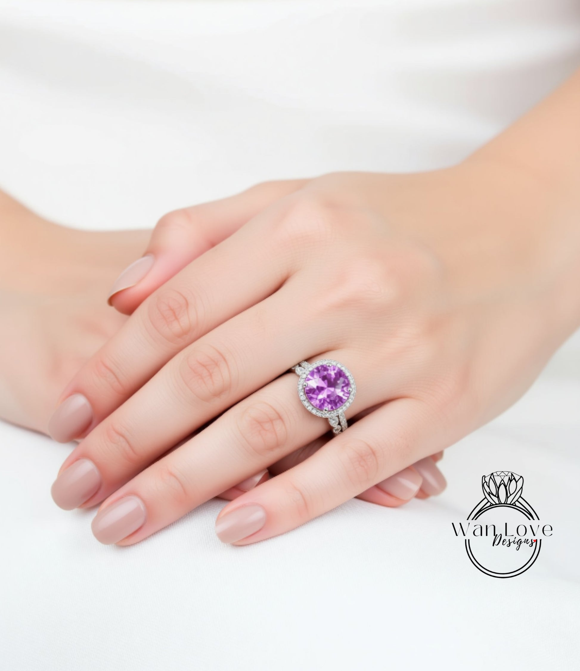 A close-up image of a person's hand wearing a large, round, purple gemstone ring.