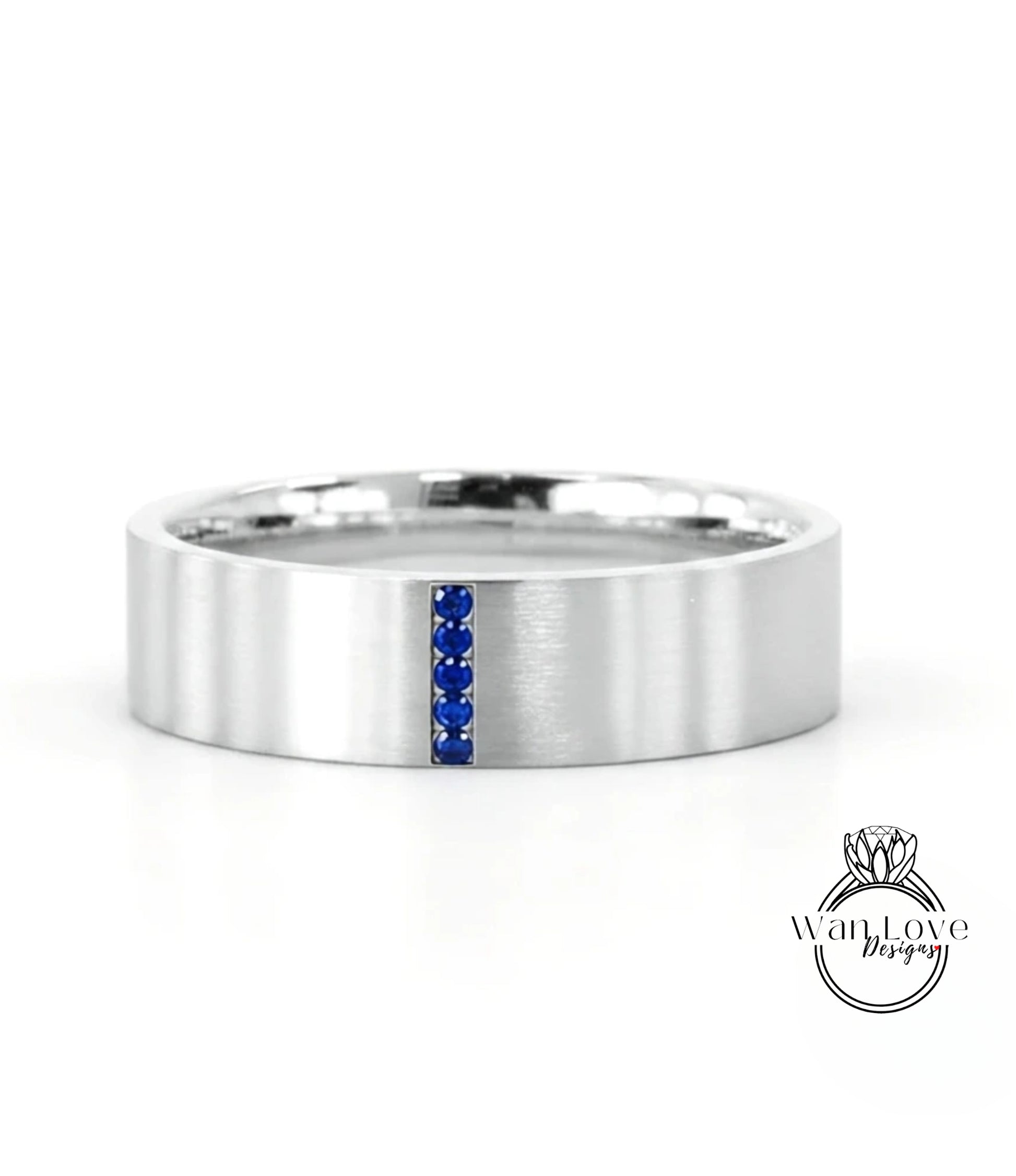 A silver-colored ring with a blue gemstone in the center, set against a white background.