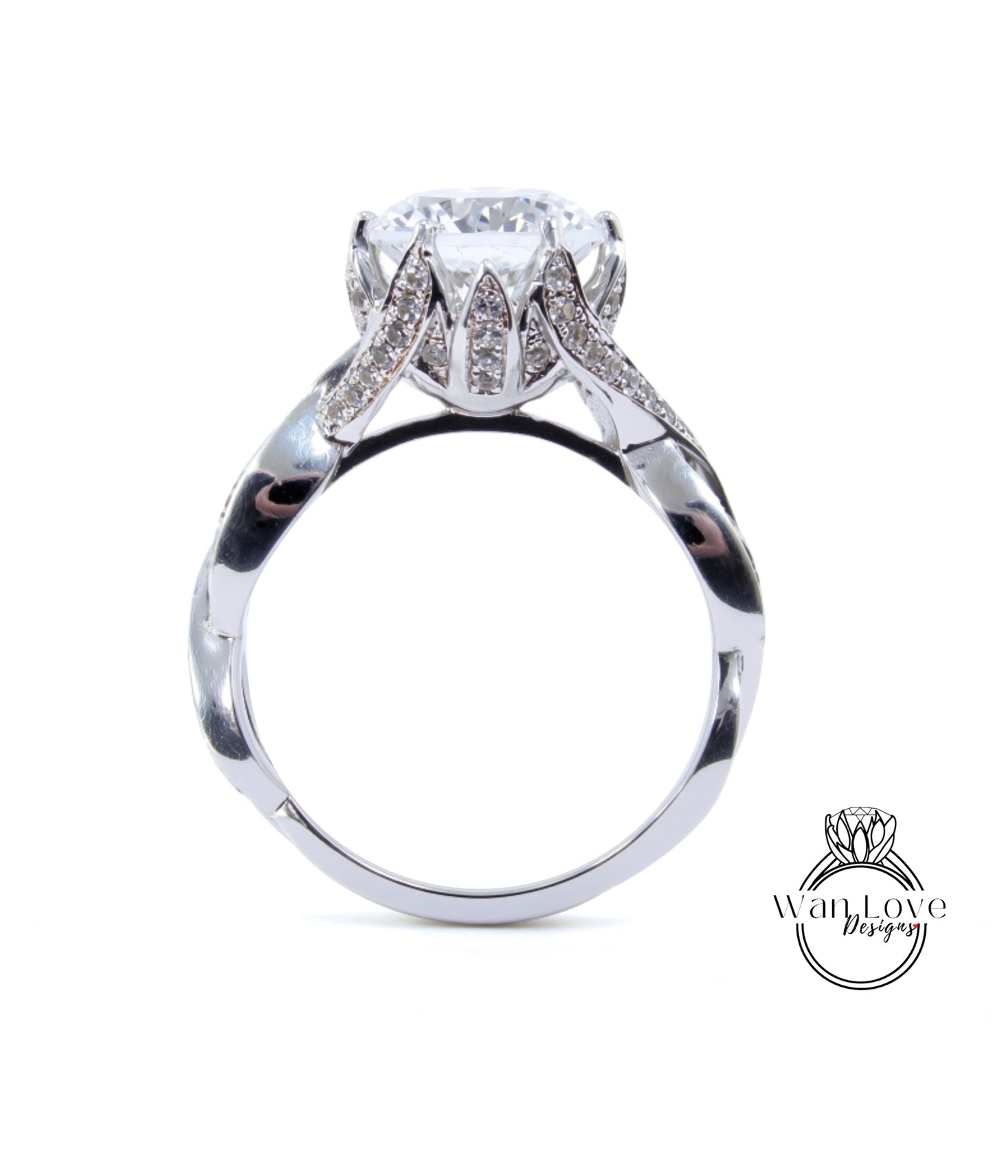 A silver ring with a large diamond set in the center, surrounded by smaller diamonds.