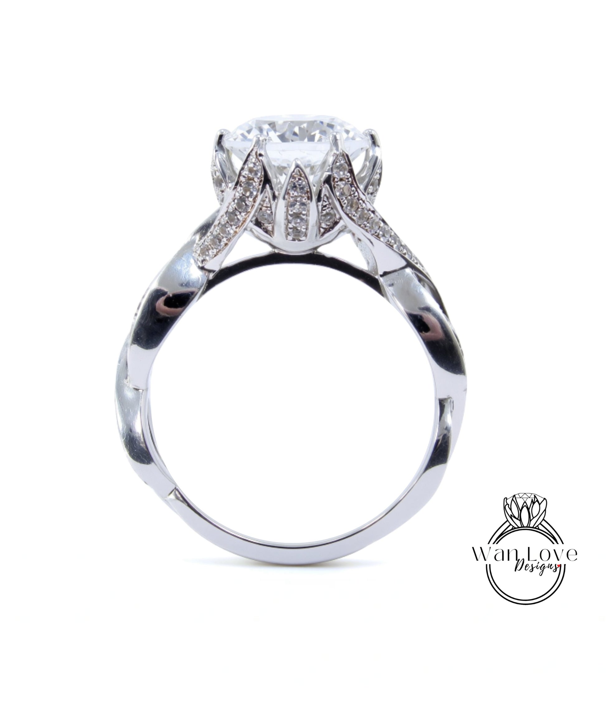 A silver ring with a large diamond set in the center, surrounded by smaller diamonds.