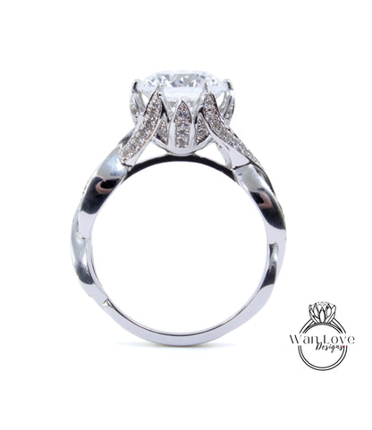 A silver ring with a large diamond set in the center, surrounded by smaller diamonds.