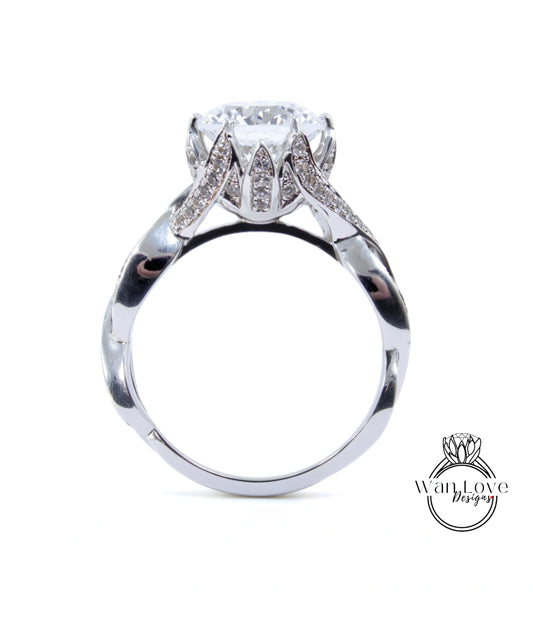 A silver ring with a large diamond set in the center, surrounded by smaller diamonds.