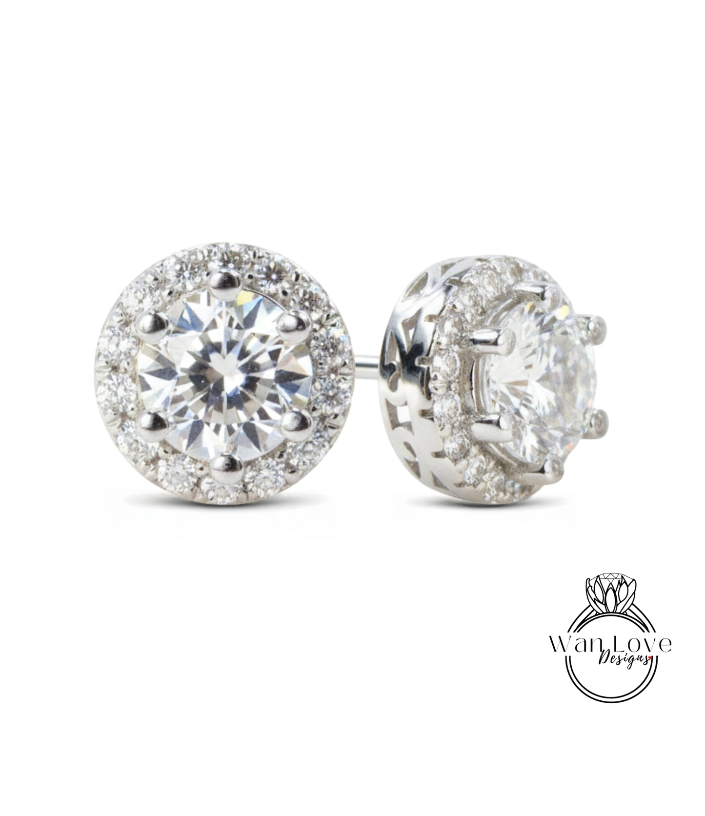 A pair of elegant earrings with a large, brilliant-cut diamond surrounded by smaller diamonds, set in a silver-toned metal.