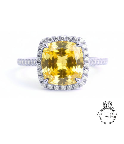 A large yellow gemstone ring with a halo of smaller diamonds around the center stone.