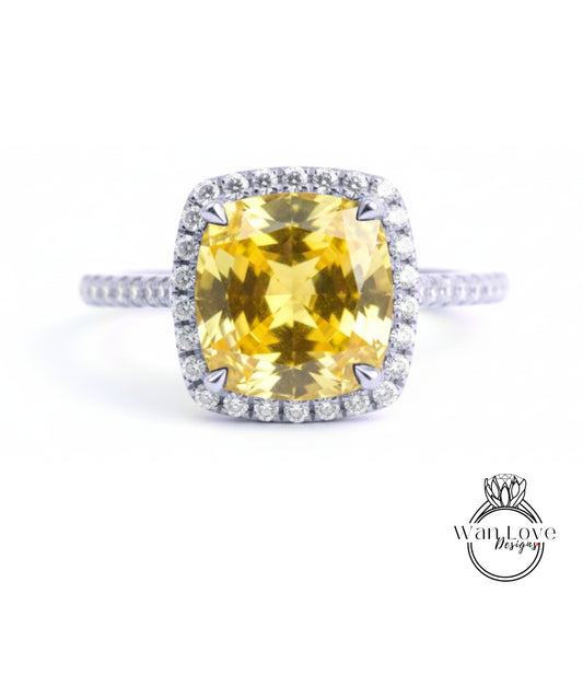 A large yellow gemstone ring with a halo of smaller diamonds around the center stone.