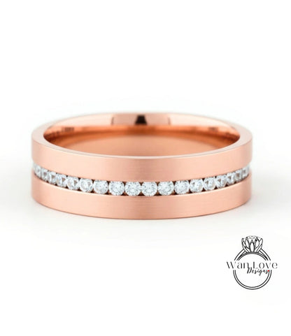 A rose gold wedding band with a row of diamonds set in the band.