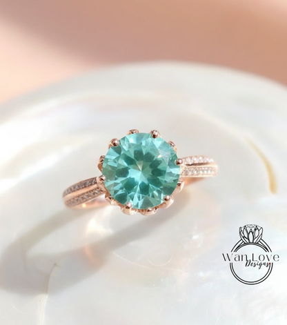 A close-up image of a rose gold ring with a large turquoise gemstone set in the center.