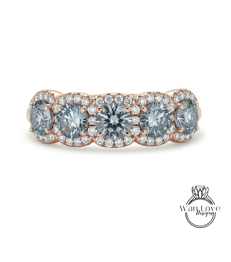 A rose gold ring with a halo of small diamonds around the center stone.