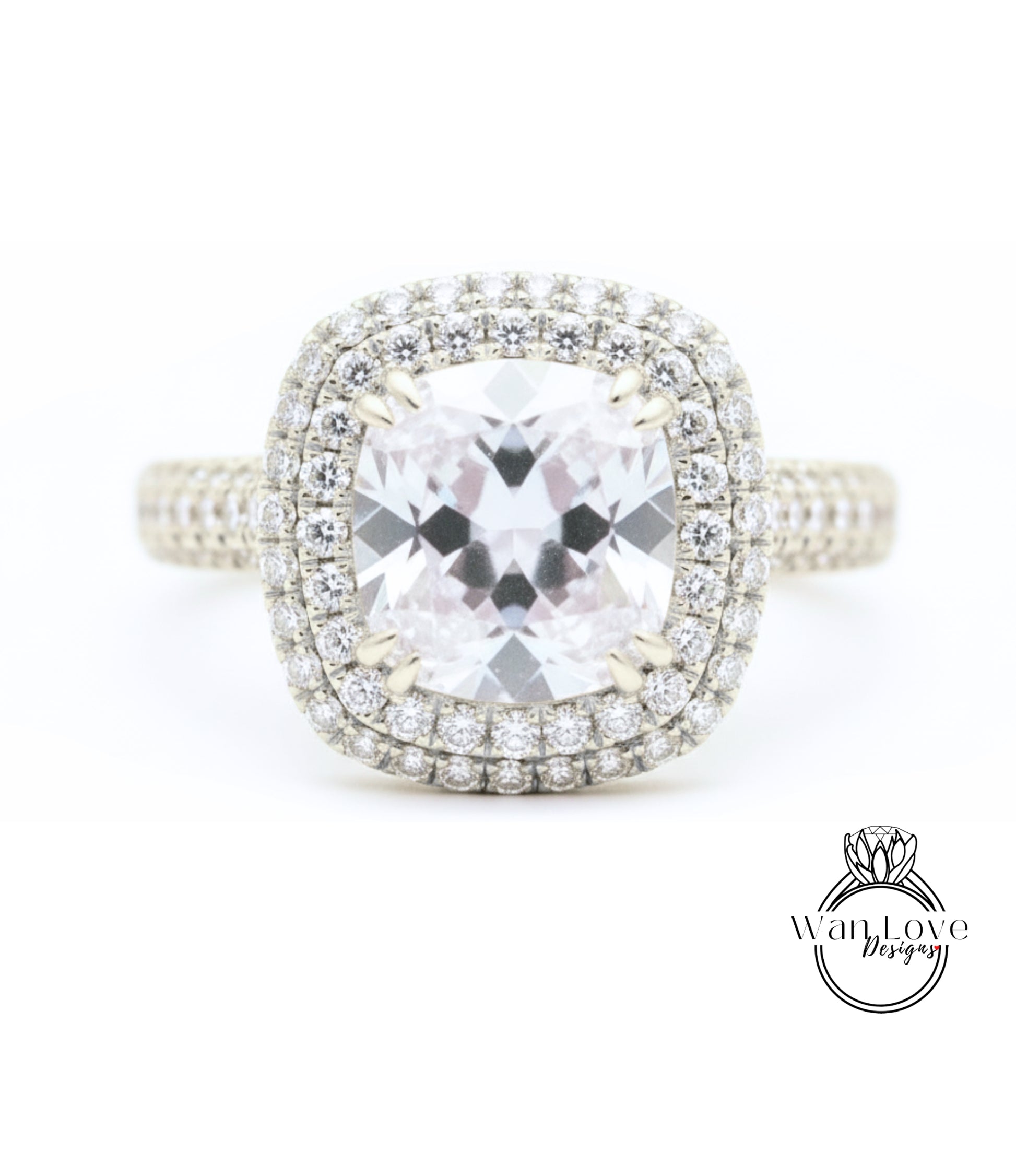 A diamond engagement ring with a large central gemstone surrounded by a halo of smaller diamonds set in a silver band.