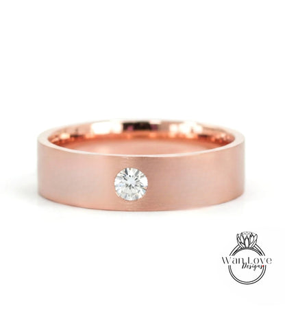 A rose gold band with a single round diamond set in the center.