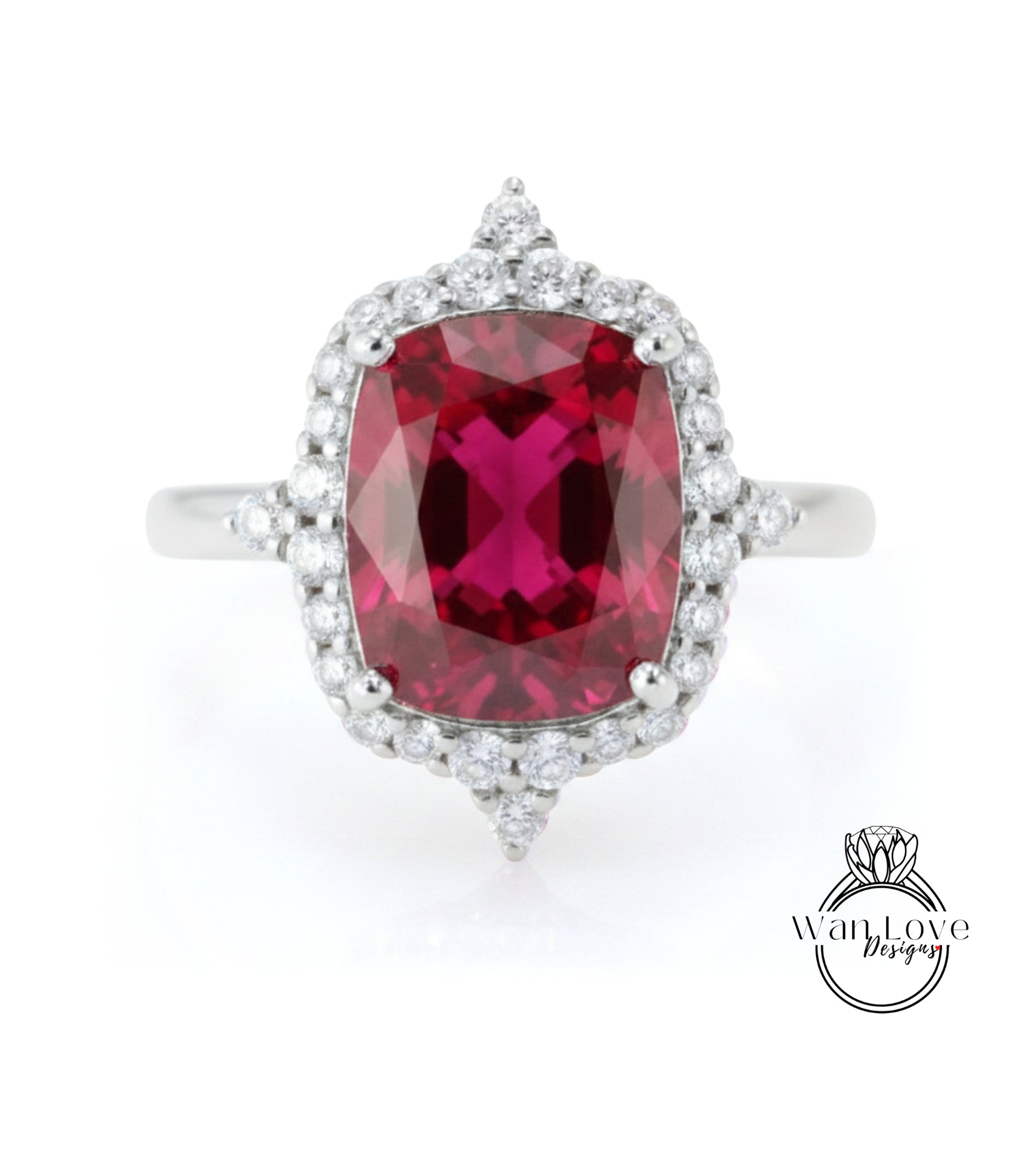 A stunning ring featuring a large, deep red gemstone surrounded by a halo of smaller diamonds, set in a silver band.