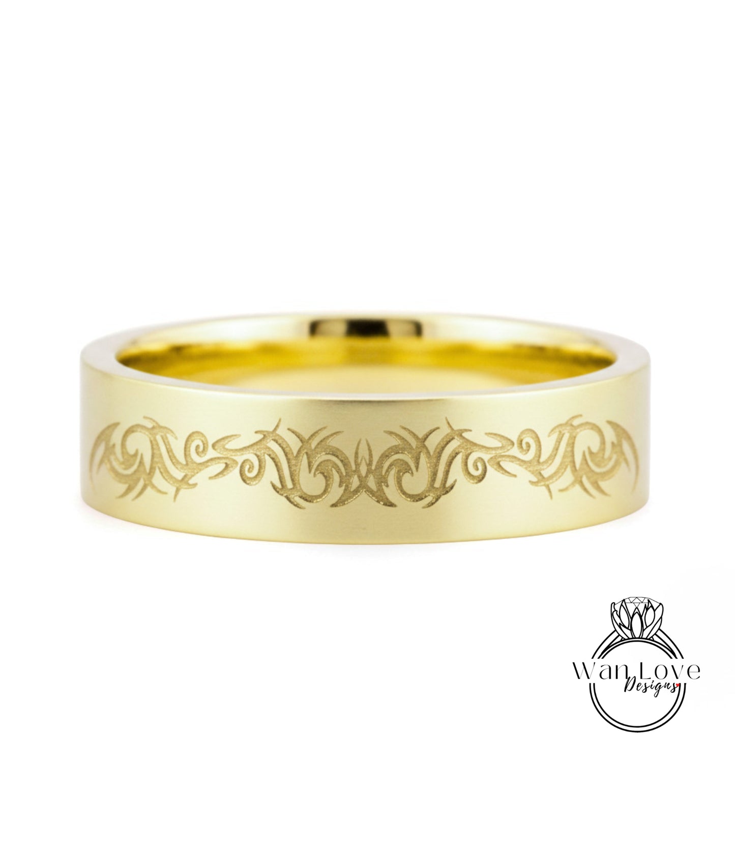 A gold ring with a decorative engraved design on the band.