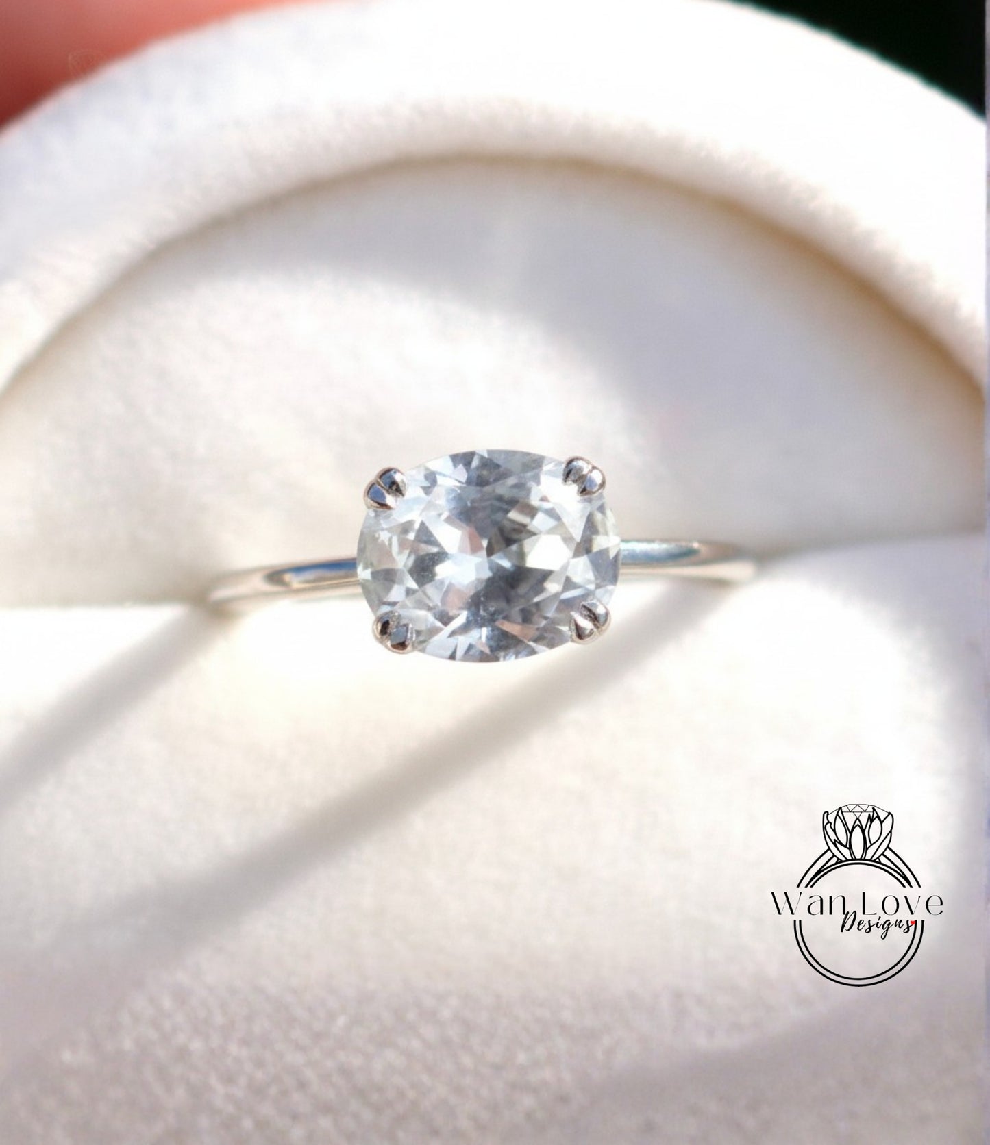 A close-up view of a diamond engagement ring with a large, clear gemstone set in a silver band.