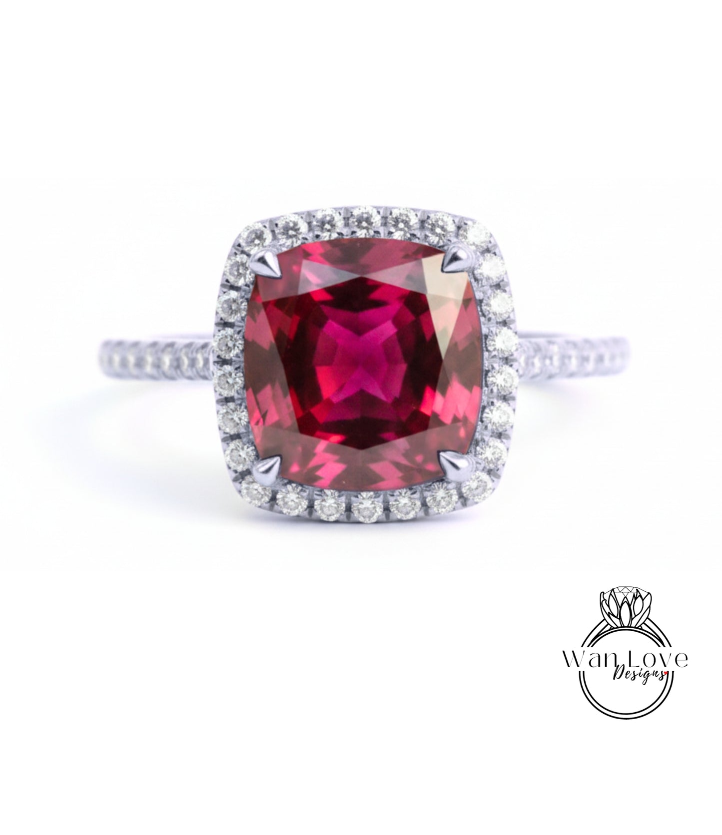A stunning ring featuring a large, deep red gemstone surrounded by a halo of smaller diamonds, set in a silver band.
