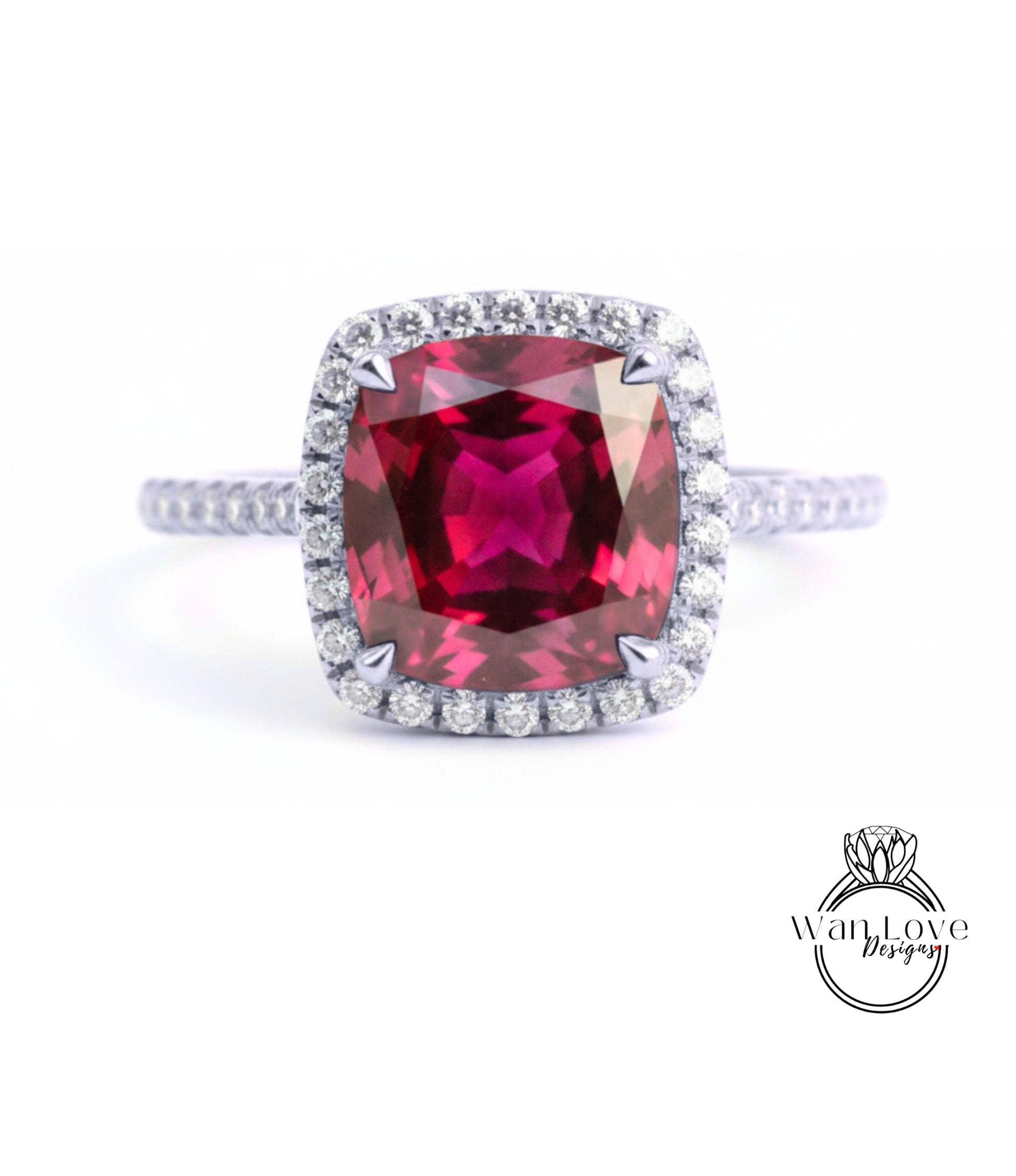 A stunning ring featuring a large, deep red gemstone surrounded by a halo of smaller diamonds, set in a silver band.