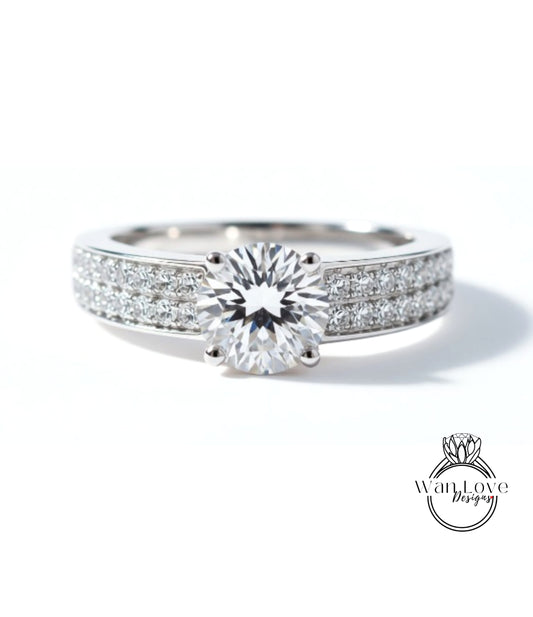 A close-up view of a diamond engagement ring with a large central diamond surrounded by smaller diamonds set in a band.