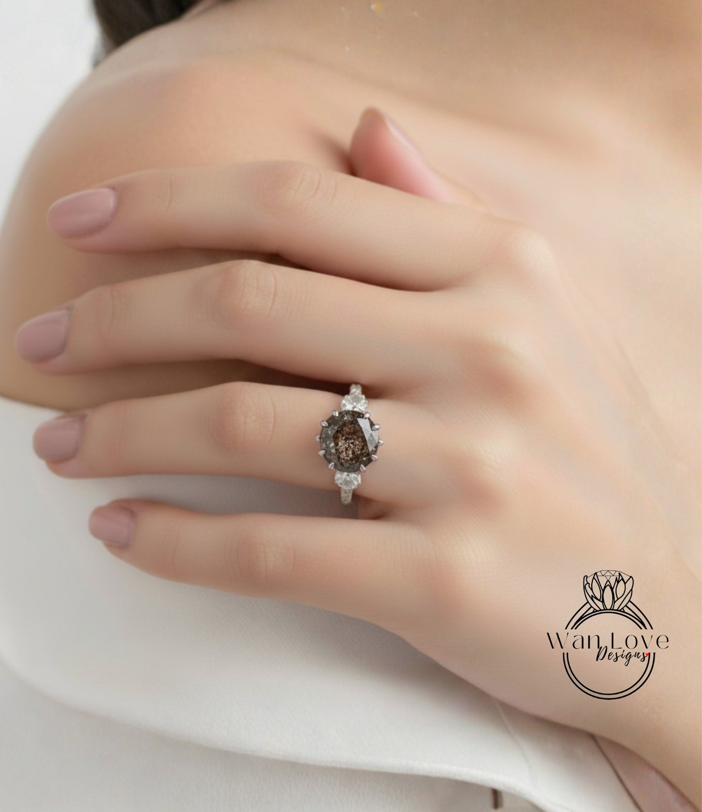 A close-up of a person's hand wearing a diamond engagement ring.