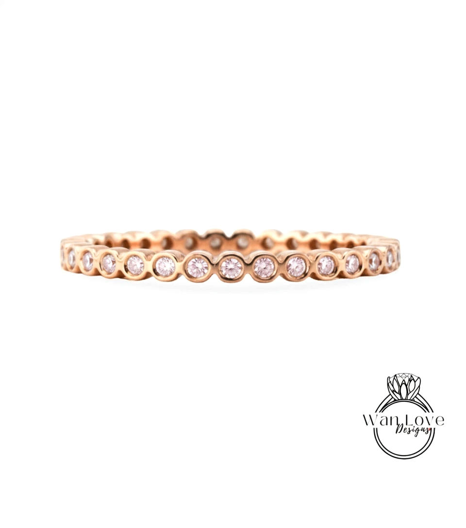 A gold-colored ring with a row of small diamonds set in the center.