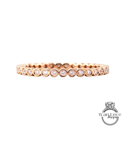 A gold-colored ring with a row of small diamonds set in the center.