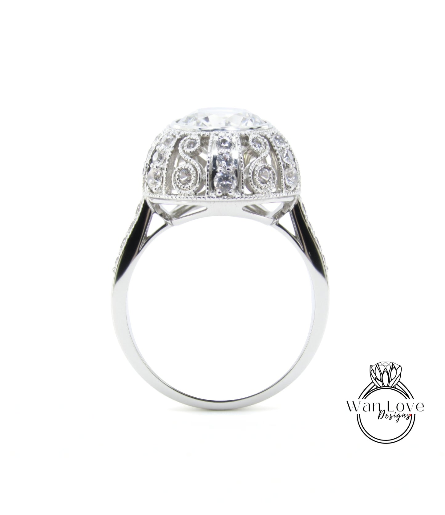 A silver ring with a large, round diamond at the center, surrounded by intricate designs.