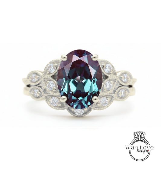 a silver ring with a large oval-shaped gemstone, likely a sapphire, surrounded by smaller diamonds.