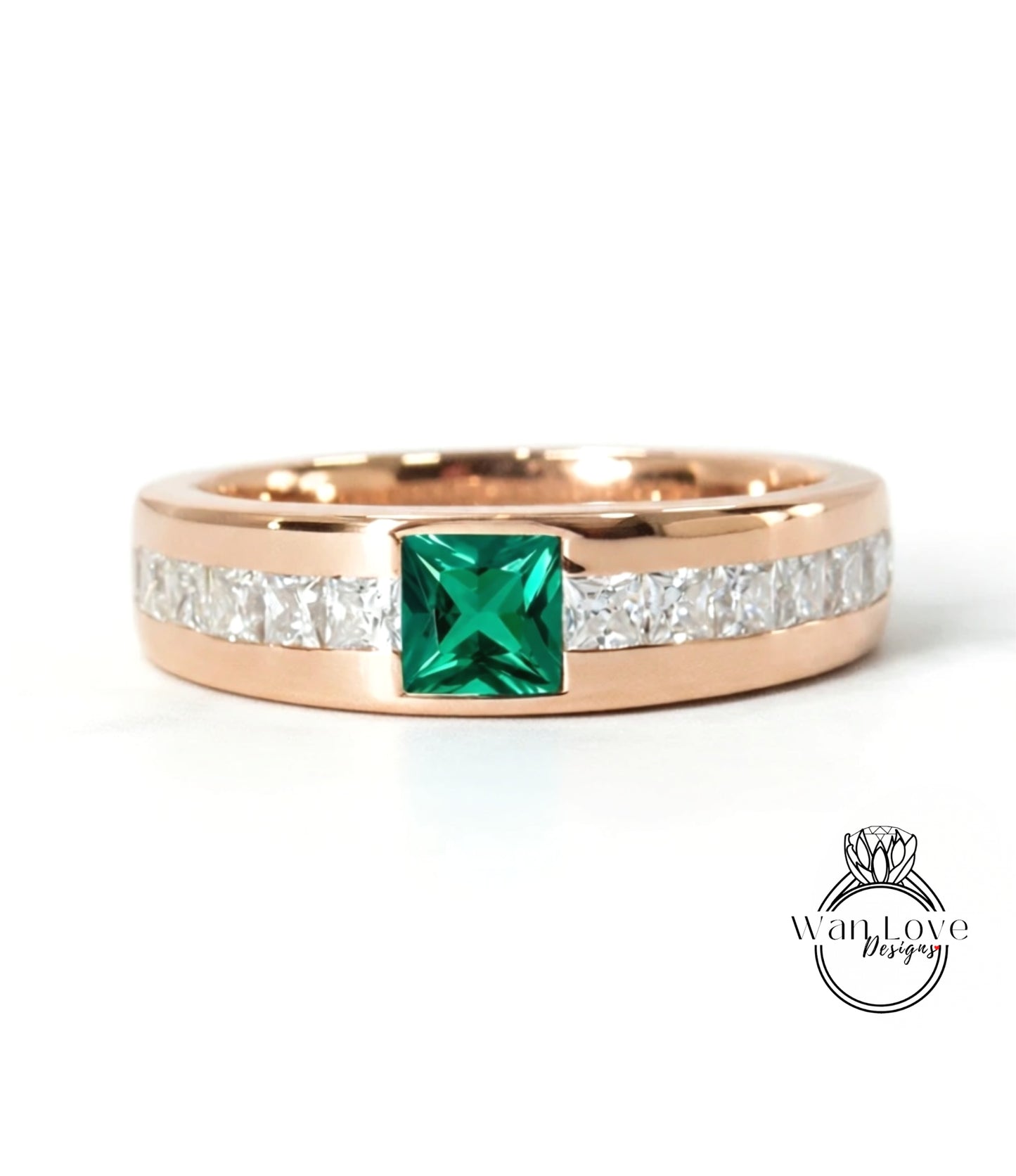 A gold ring with a large green gemstone in the center, surrounded by smaller diamonds.