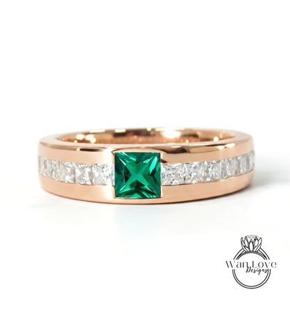 A gold ring with a large green gemstone in the center, surrounded by smaller diamonds.