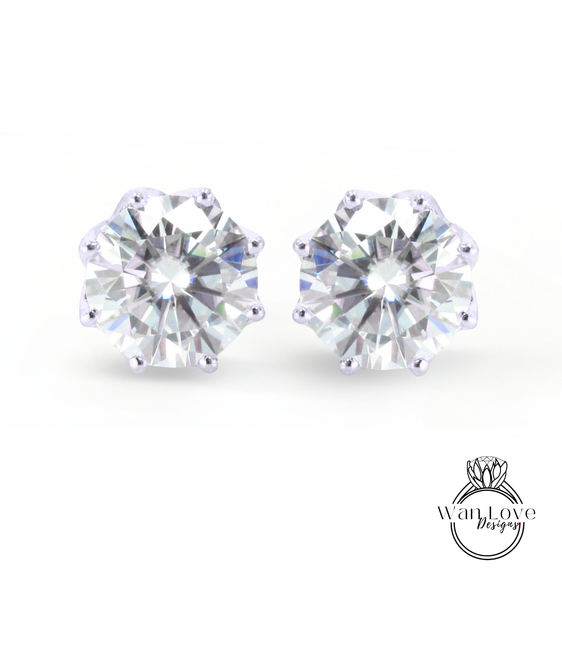 A pair of elegant earrings featuring a large, brilliant-cut diamond set in a silver-colored metal.