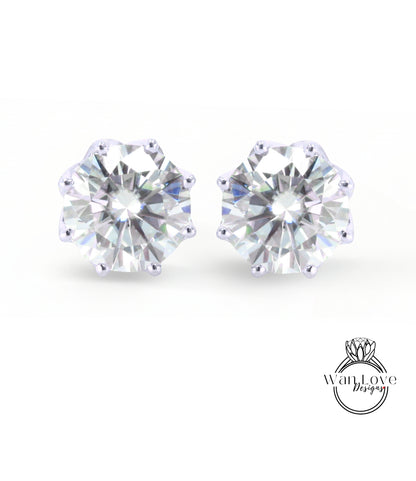 A pair of elegant earrings featuring a large, brilliant-cut diamond set in a silver-colored metal.