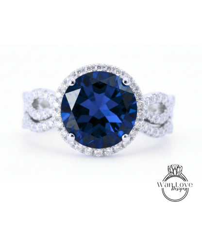 A stunning blue gemstone ring with a halo of diamonds around the center stone.