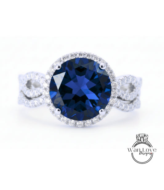 A stunning blue gemstone ring with a halo of diamonds around the center stone.