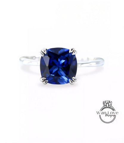 A ring with a large blue gemstone, likely a sapphire, set in a silver band.