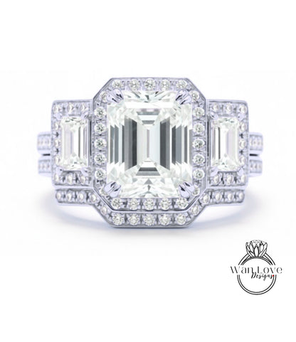 A stunning diamond engagement ring with a large central diamond surrounded by smaller diamonds on either side, set in a silver band.