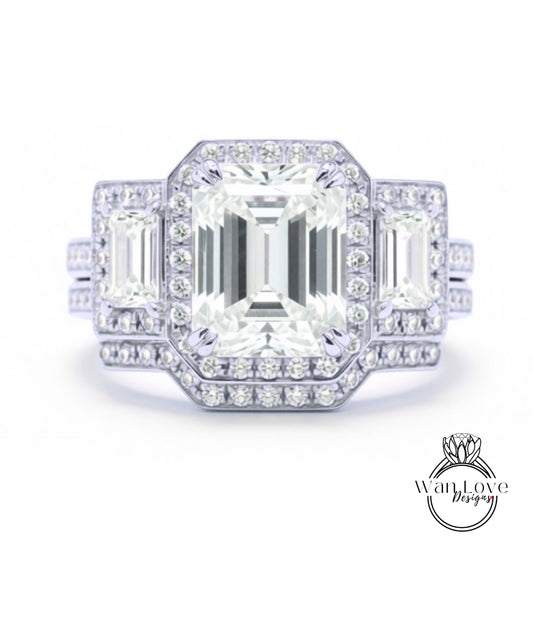 A stunning diamond engagement ring with a large central diamond surrounded by smaller diamonds on either side, set in a silver band.