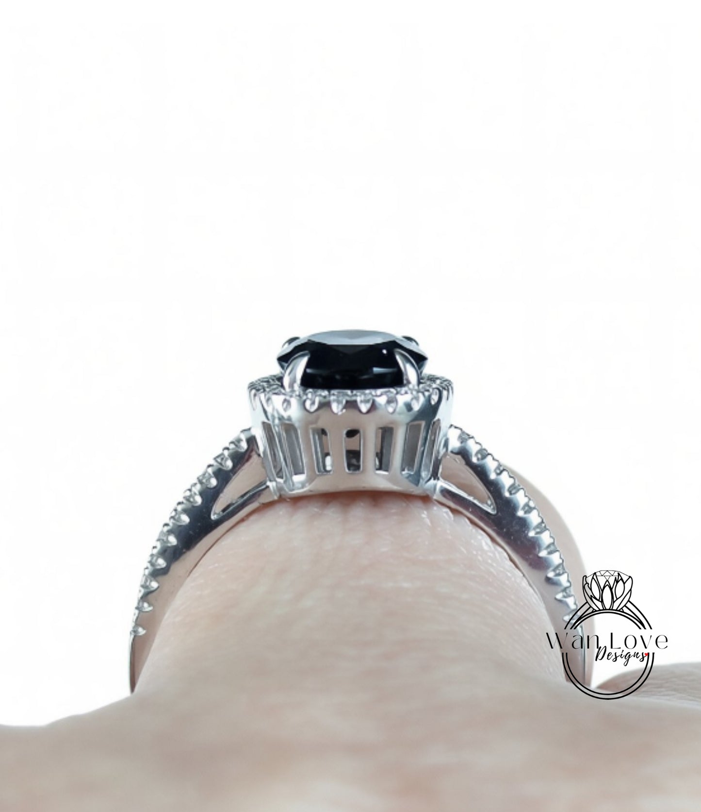 A close-up view of a silver ring with a large black gemstone, showcasing the intricate details and craftsmanship of the jewelry piece.