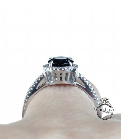 A close-up view of a silver ring with a large black gemstone, showcasing the intricate details and craftsmanship of the jewelry piece.