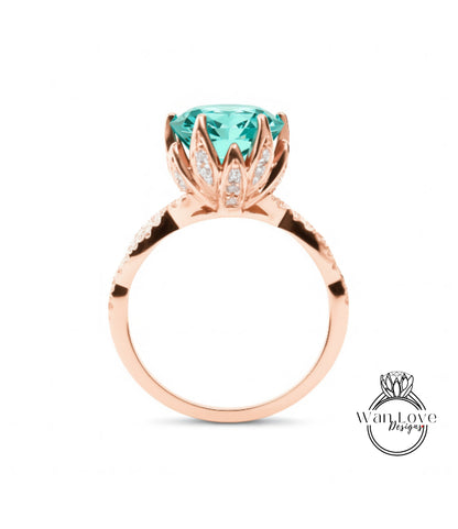 A rose gold ring with a large turquoise gemstone set in the center, surrounded by smaller diamonds.