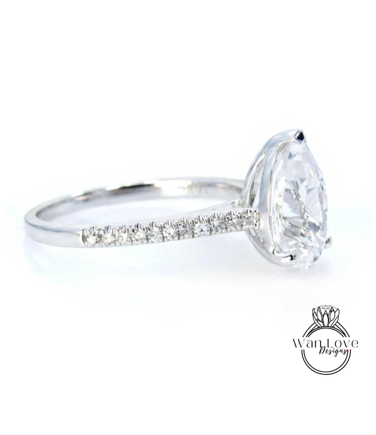 A close-up view of a diamond engagement ring with a large central diamond and a row of smaller diamonds along the band.