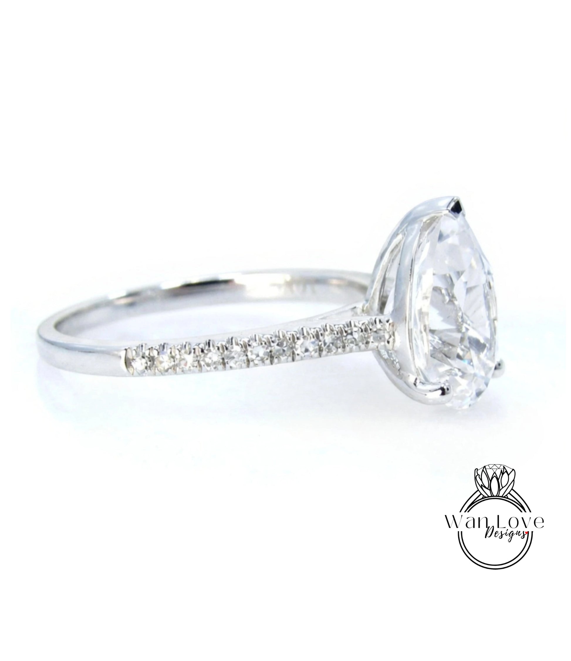 A close-up view of a diamond engagement ring with a large central diamond and a row of smaller diamonds along the band.