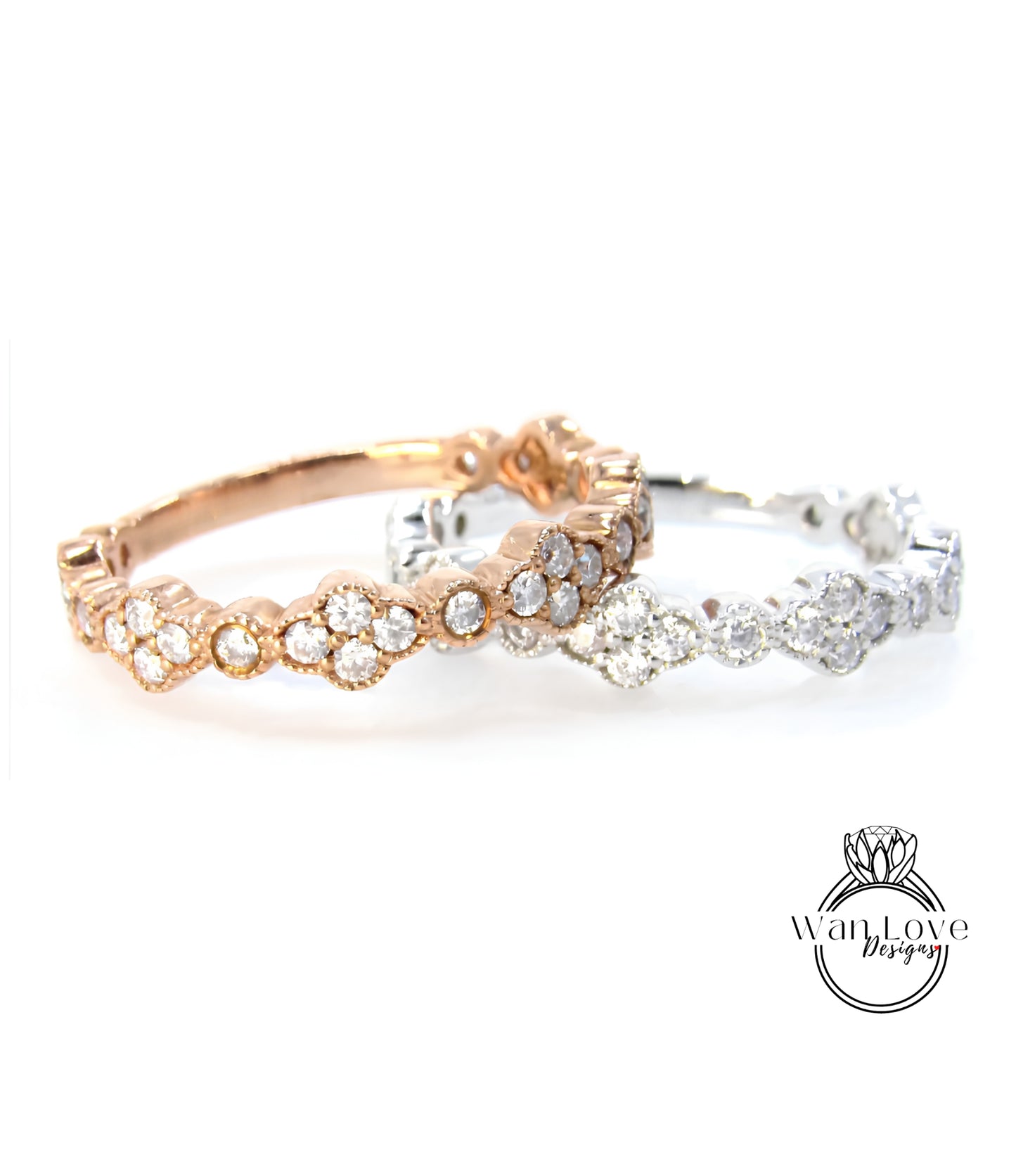 two rings with a combination of gold and silver tones, adorned with numerous small diamonds.