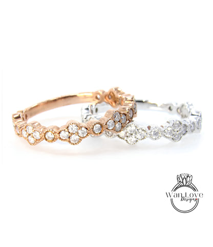 two rings with a combination of gold and silver tones, adorned with numerous small diamonds.