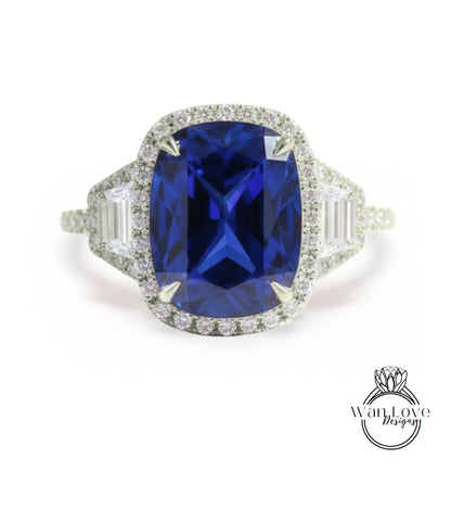 A stunning diamond engagement ring with a large, deep blue gemstone set in a halo of smaller diamonds.