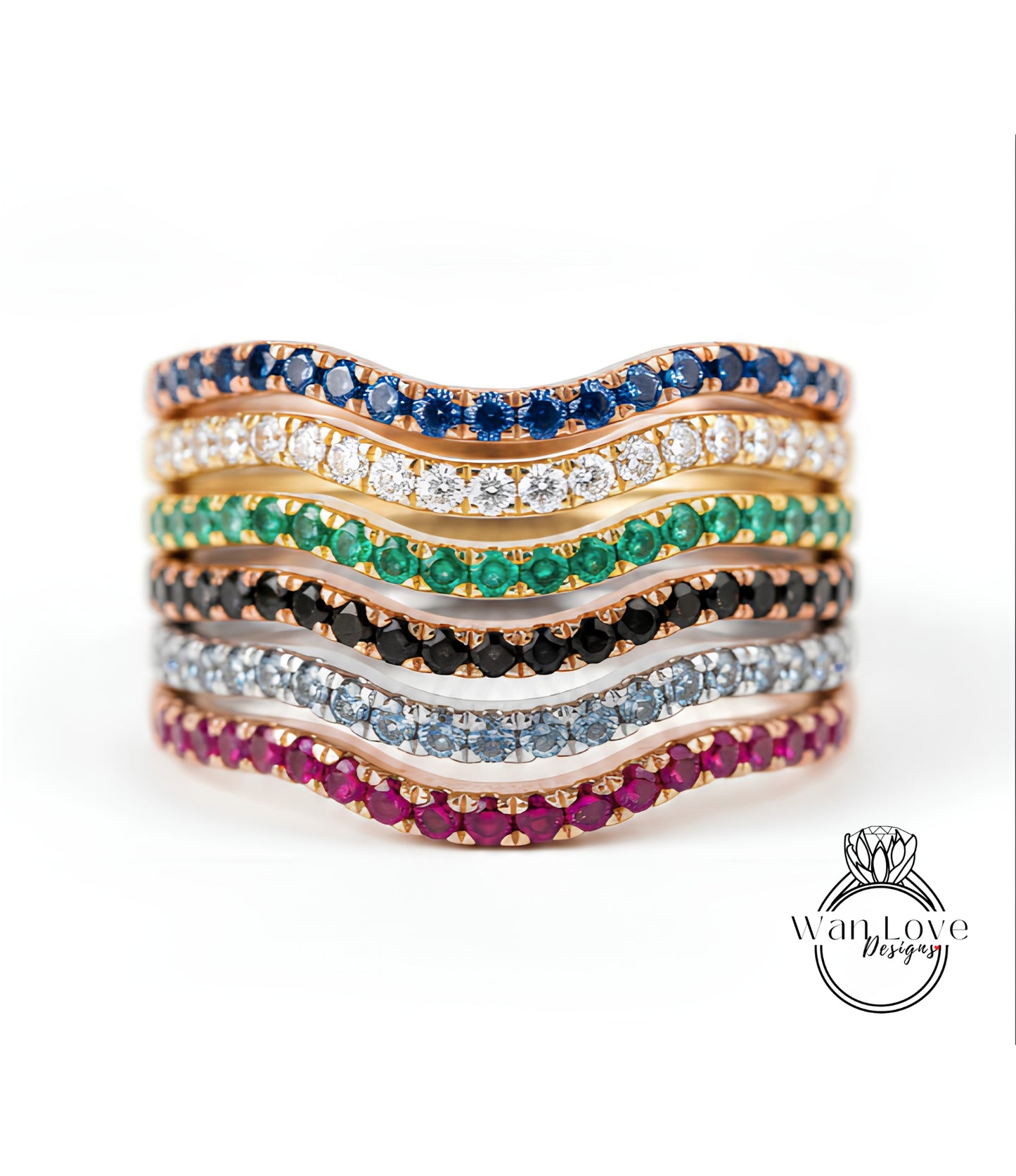 A stack of rings with various colored gemstones, including blue, green, red, and white stones, arranged in a wavy pattern.