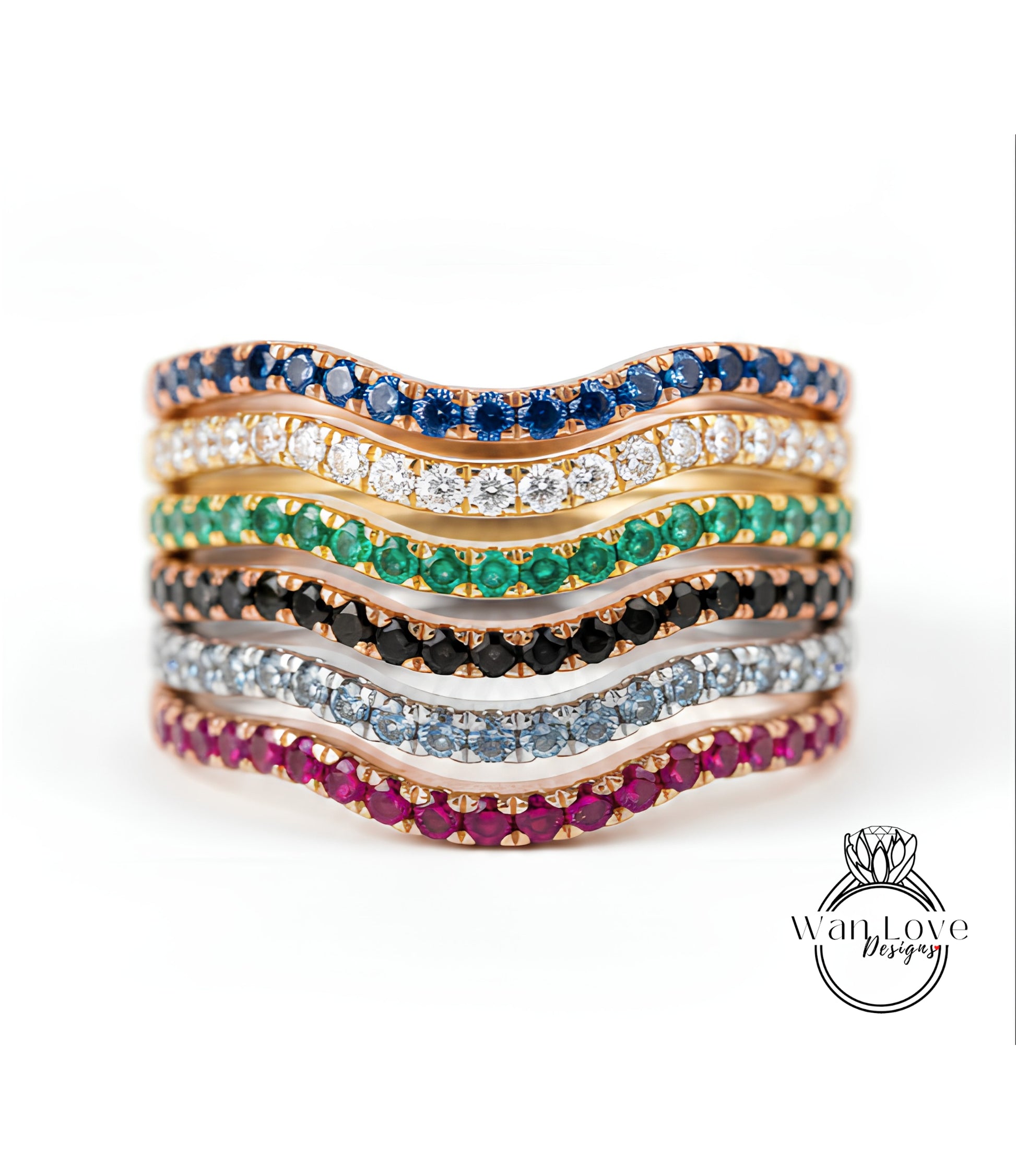 A stack of rings with various colored gemstones, including blue, green, red, and white stones, arranged in a wavy pattern.