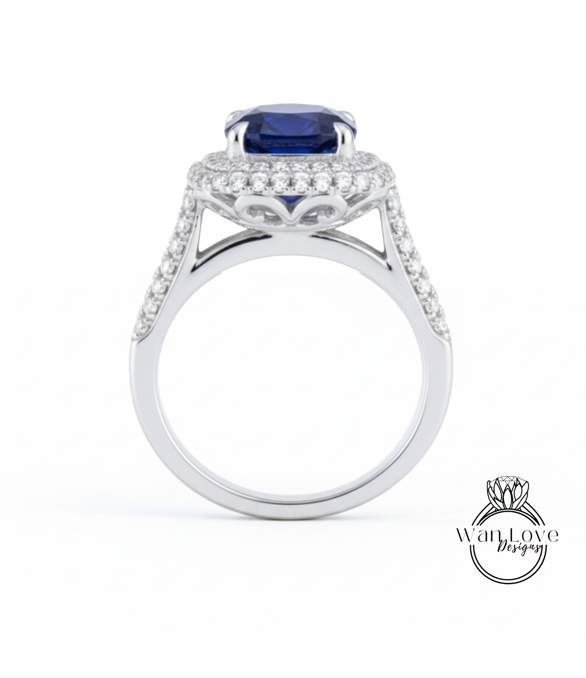 A silver ring with a large blue gemstone, likely a sapphire, set in a halo of smaller diamonds.